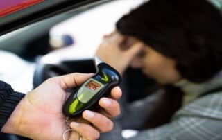 DUI Law Firm Denver’s Best Ways to Challenge DUI Evidence in Colorado shows breathalyzer tests and driver distress highlighting possible defense issues.