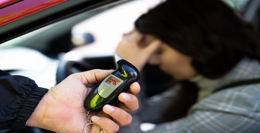 DUI Law Firm Denver’s Best Ways to Challenge DUI Evidence in Colorado shows breathalyzer tests and driver distress highlighting possible defense issues.