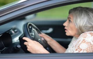 An elderly driver looks startled behind the wheel—raising the question: Can Age Affect DUI Tests? DUI Law Firm Denver explains how age may play a role.