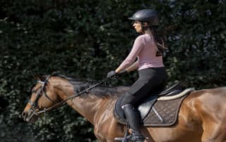 A woman rides a horse confidently—Can I Get a DUI While Riding a Horse? DUI Law Firm Denver breaks down what Colorado law really says.