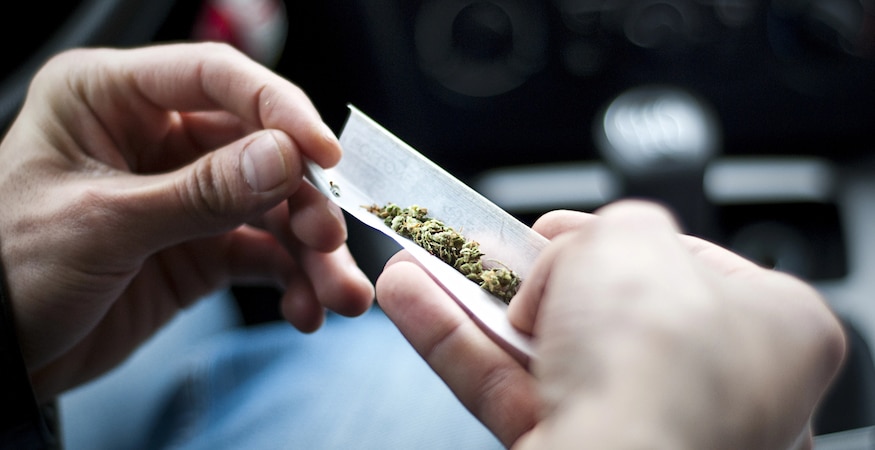 Can Marijuana Smell Alone Lead to a DUI Hands rolling a cannabis joint with paper