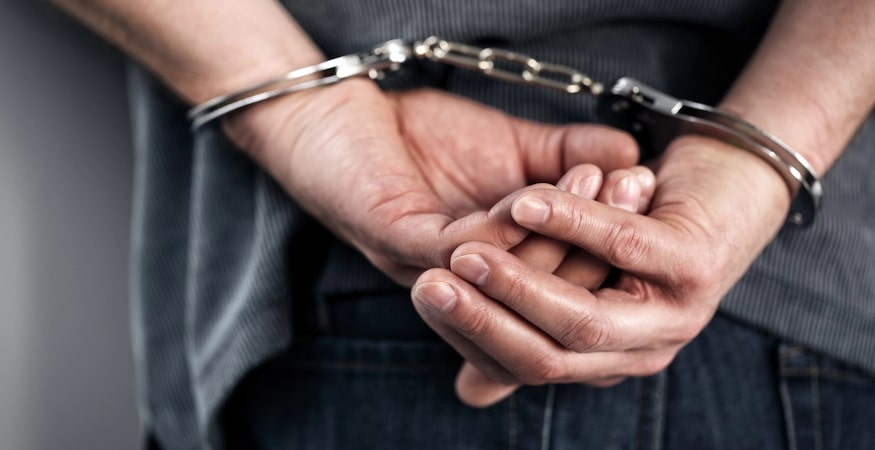How the Adult and Juvenile Criminal Processes Are Different Person with hands handcuffed behind back