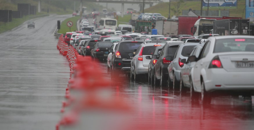 Traffic jam on rainy highway with orange cones