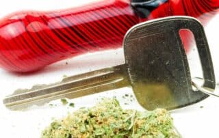 Glass pipe, car key, and cannabis