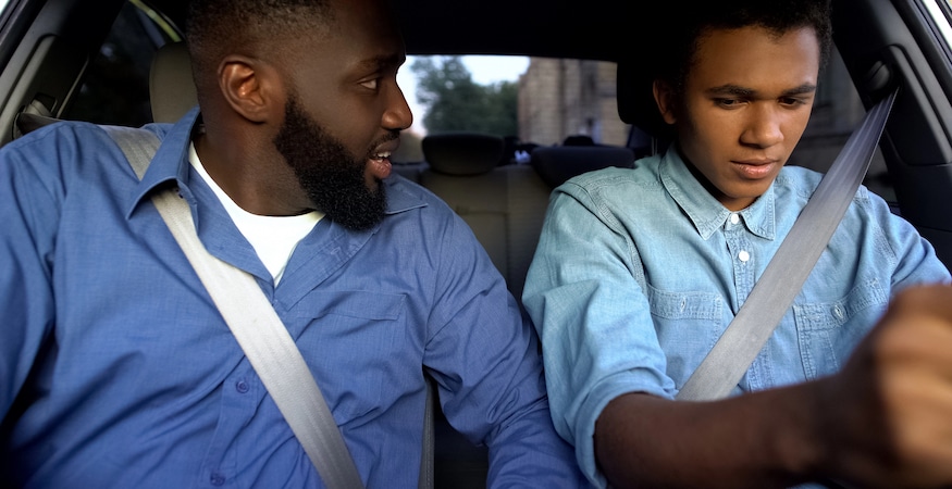Parents How to Respond When Your Child Gets in Legal Trouble Adult teaching teenager to drive in car