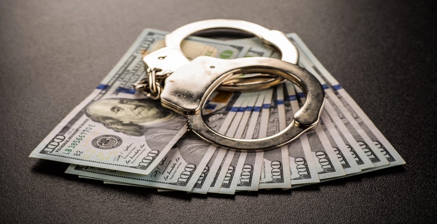 Handcuffs rest on cash—Tips to Save Money After a Colorado DUI are crucial. DUI Law Firm Denver helps reduce the financial burden of a DUI charge.