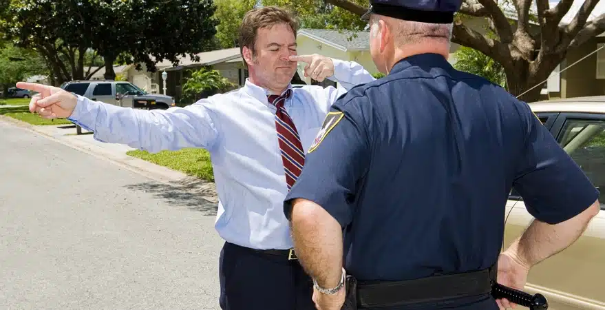 Understanding field sobriety tests in Colorado, showing an officer conducting a roadside sobriety test on a man outdoors, highlighting balance, coordination, eye movement, and behavioral cues officers use to assess impairment.