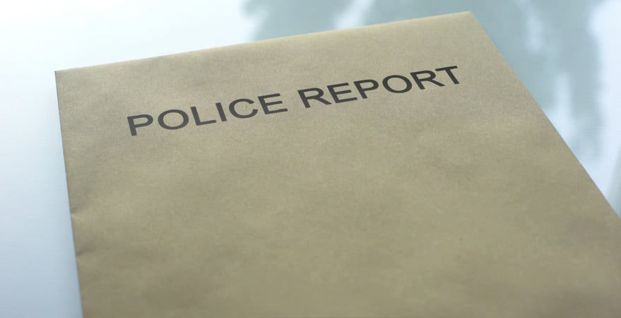 DUI Law Firm Denver: Police report and documents on a table represent what is included in a DUI police report under Colorado DUI Law and procedure.